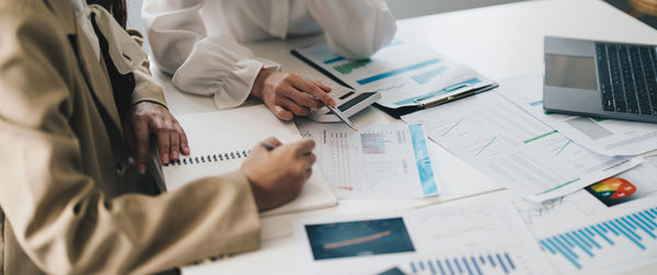 Midsection of business colleagues working in office