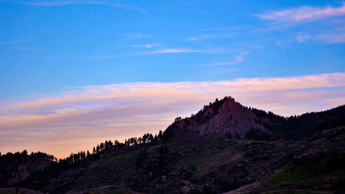 Scenic view of mountains against cloudy sky