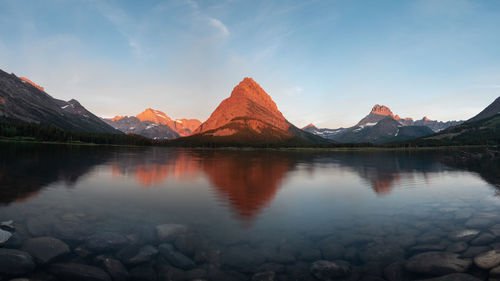 Scenic view of lake and mountains against sky