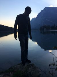 Rear view of man standing in lake