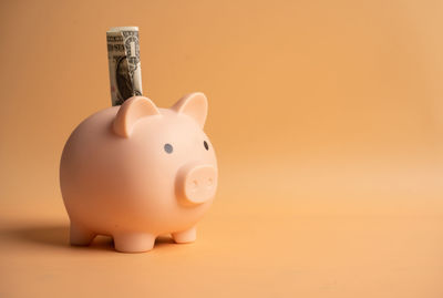 Close-up of electric lamp against orange background