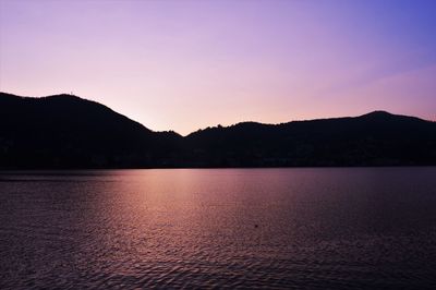 Scenic view of lake against sky at sunset