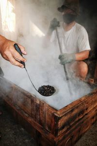 Midsection of man preparing food