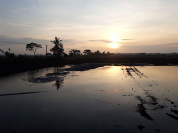 Scenic view of lake against sky during sunset
