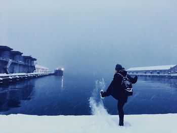 Full length of man on snow against clear sky