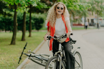 Full length portrait of woman with bicycle