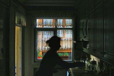 Silhouette of person cooking in kitchen