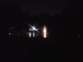 Illuminated lights in water at night