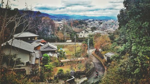 Houses and trees against sky