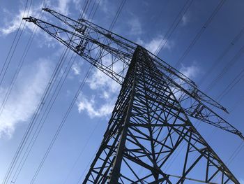 Low angle view of electricity pylon against sky