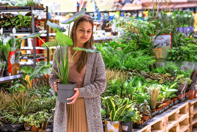 Portrait of smiling young woman standing outdoors