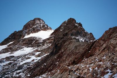 Scenic view of mountains against clear blue sky during winter