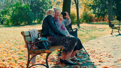 Woman sitting on bench in park