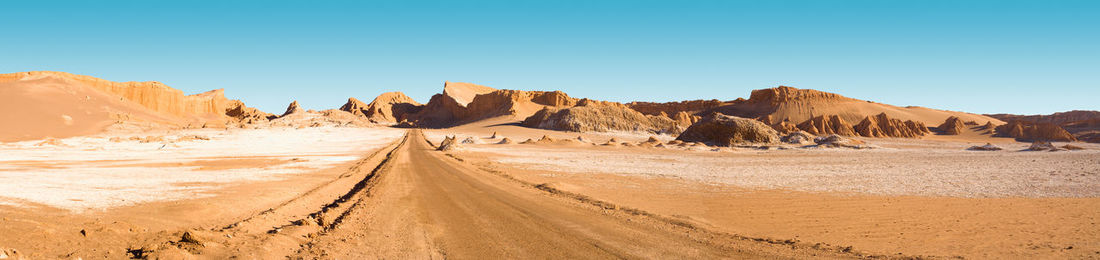 Panoramic view of arid landscape against clear sky