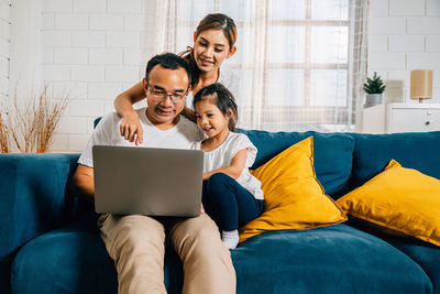 Young woman using laptop at home