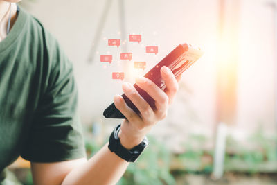 Midsection of woman holding smart phone