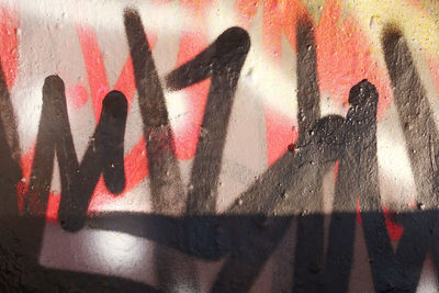 Shadow of graffiti on wall