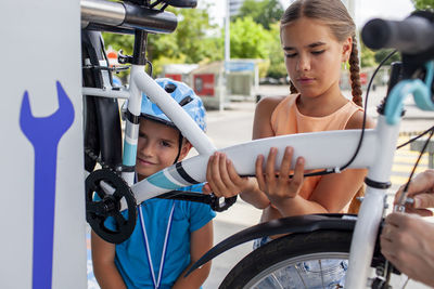 Portrait of smiling young woman holding wheelchair