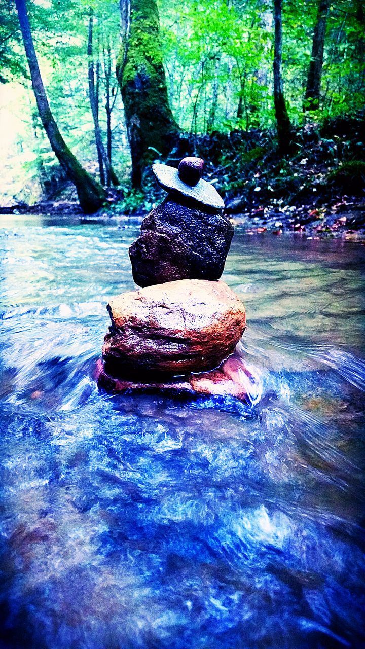 STACK OF STONES ON ROCK IN WATER