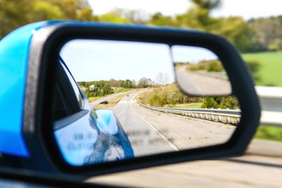 Reflection of car on side-view mirror