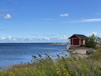 House by sea against sky