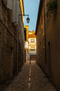 Narrow alley amidst buildings in city