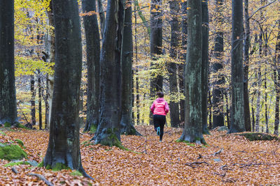 Mother and son running in forest