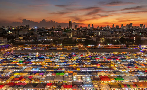 High angle view of illuminated buildings against sky at sunset