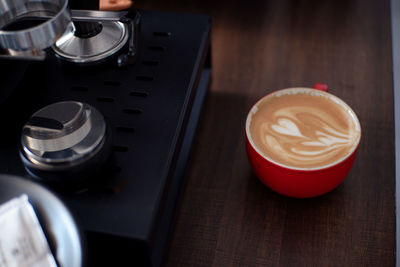 Cup of latte coffee on wooden table