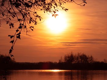 Scenic view of lake against romantic sky at sunset