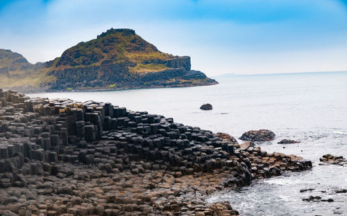 Rocks on beach against sky