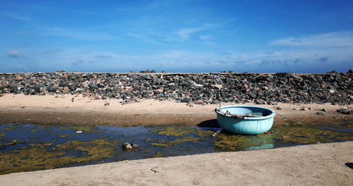 Garbage on beach against blue sky