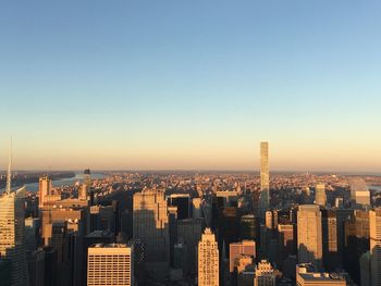 Modern buildings in city against clear sky