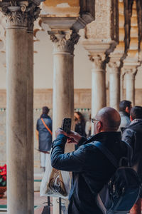 Rear view of man photographing