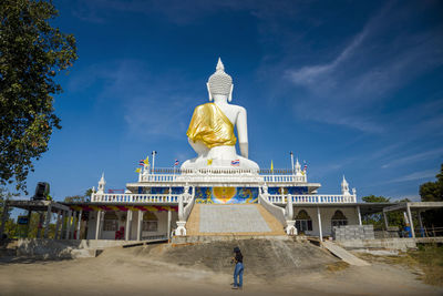 Statue of temple against cloudy sky