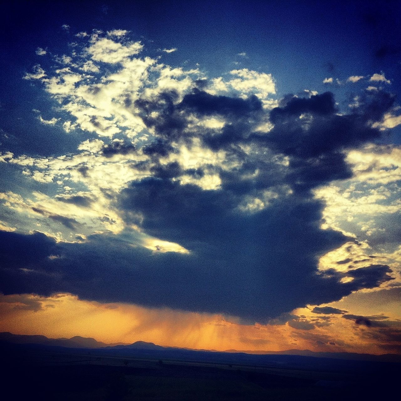 scenics, tranquility, sky, tranquil scene, beauty in nature, cloud - sky, sunset, nature, idyllic, silhouette, blue, cloud, landscape, majestic, low angle view, cloudscape, outdoors, no people, cloudy, dramatic sky