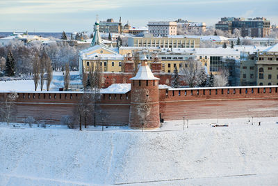 Buildings in city against sky during winter