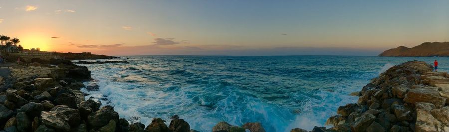 Panoramic view of sea against sky during sunset