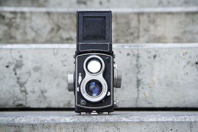 Close-up of vintage camera on wall