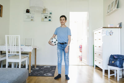 Boy with football at home