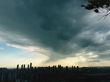 Low angle view of silhouette buildings against sky