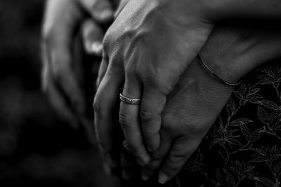 Cropped image of couple holding hands