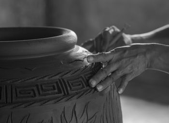 Close-up of potter carving pot at workshop