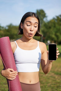 Portrait of young woman using mobile phone