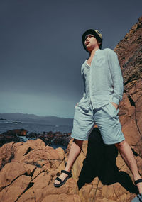 Portrait of young man standing on mountain