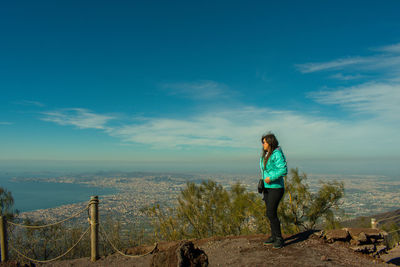 Full length of woman standing on land against sky