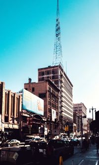 View of buildings in city against blue sky