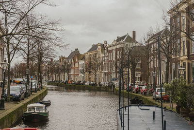 Panoramic view of canal amidst buildings against sky