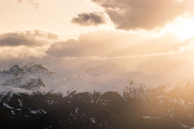 Scenic view of snowcapped mountains against sky during sunset