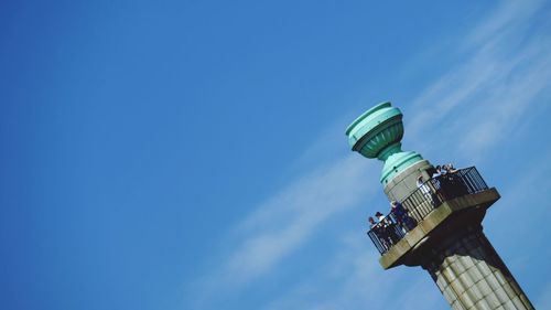 Tilt shot of people at observation point against sky